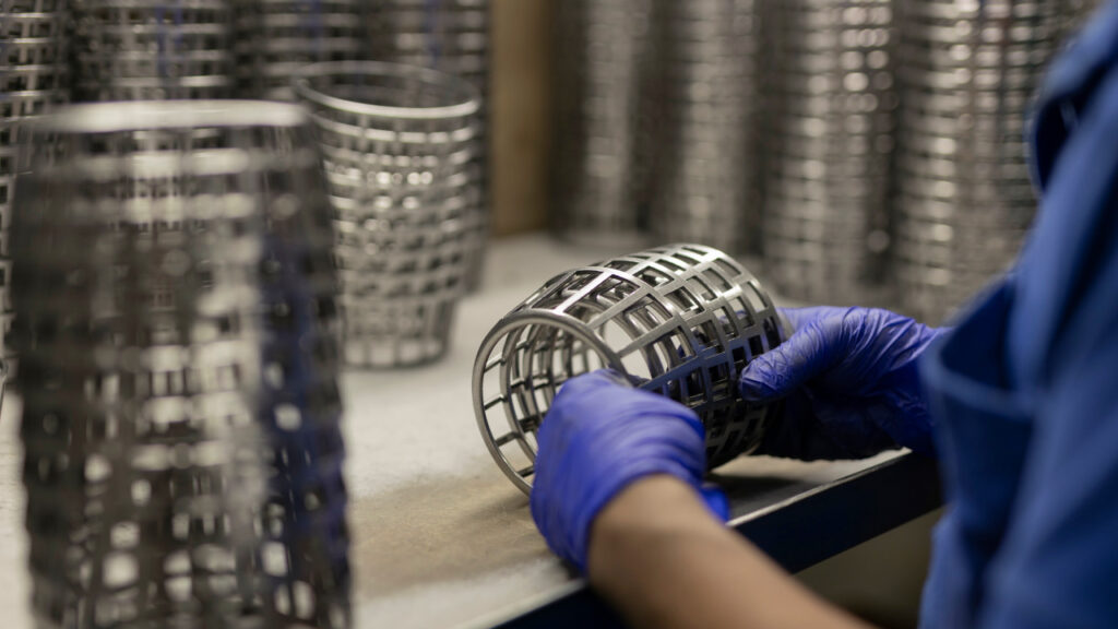 Worker arranging bearing cages for packing and delivery at Prime Cage
